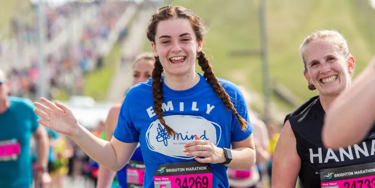 woman running in race wearing mind t shirt and smiling woman running in race wearing mind t shirt and smiling