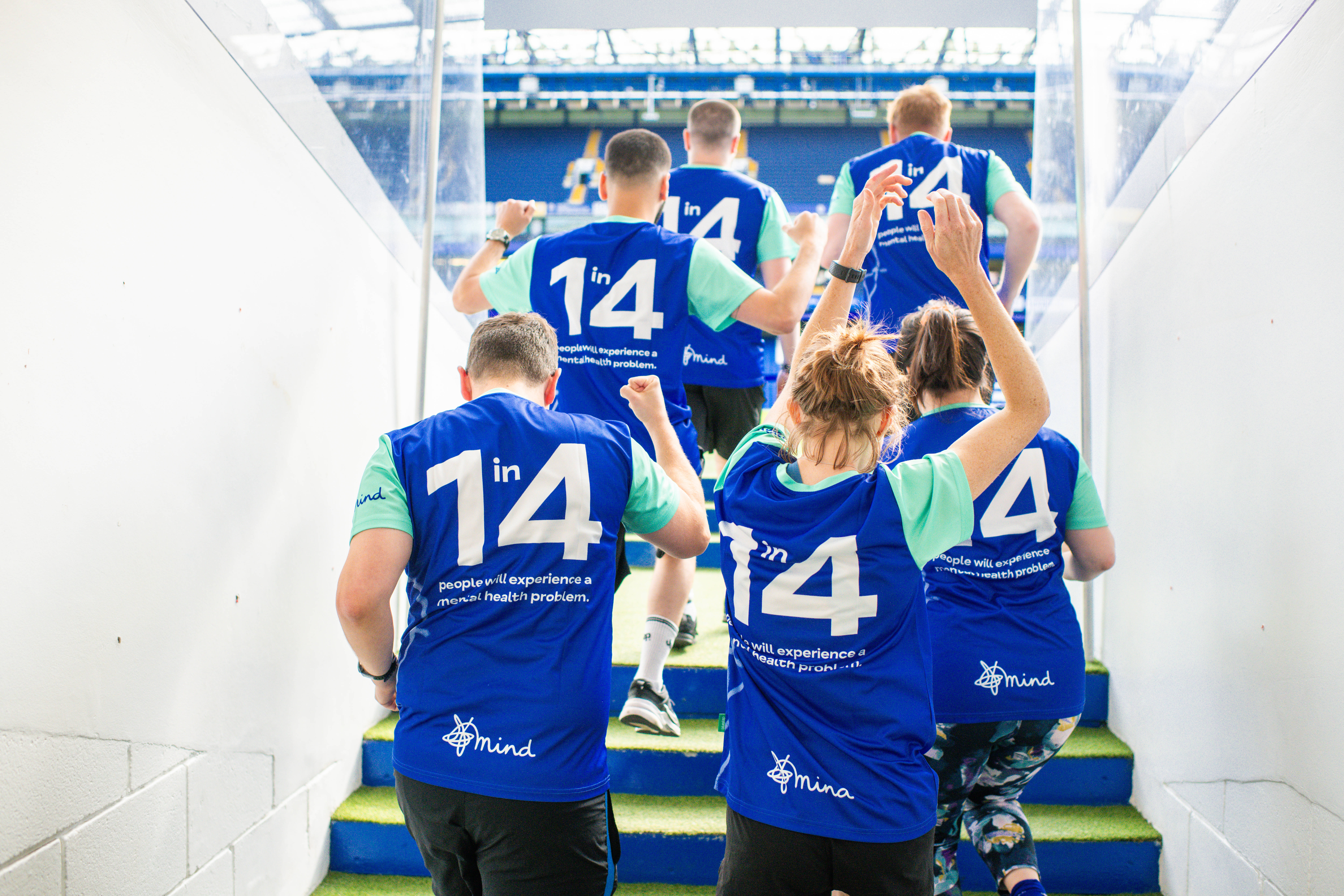Group of people running out of the tunnel at Stamford Bridge