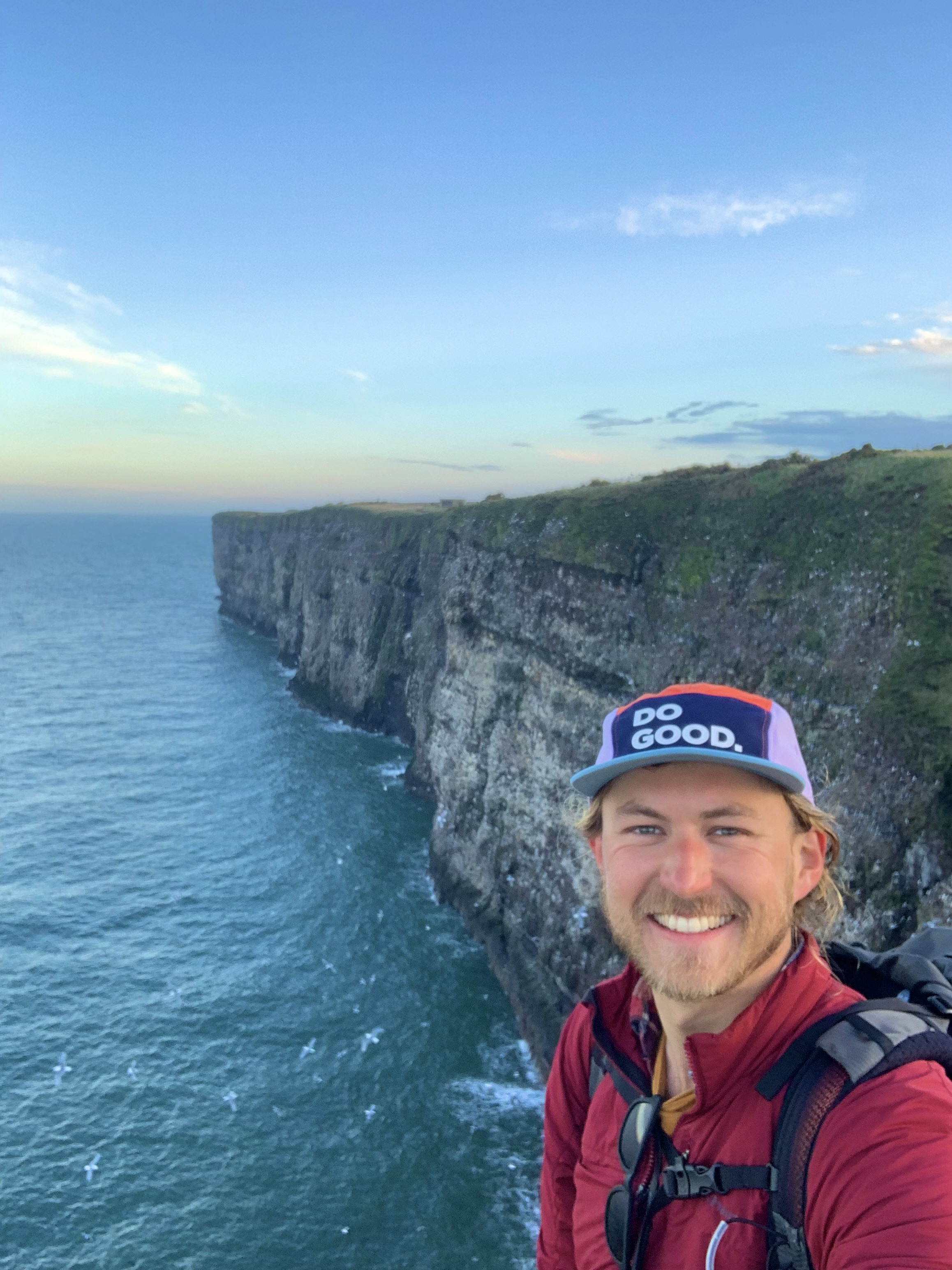 Mind fundraiser James smiling in front of the coast at Aberdeenshire