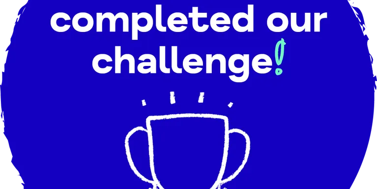 Blue circle with white text 'We have completed our challenge' with illustration of trophy Blue circle with white text 'We have completed our challenge' with illustration of trophy